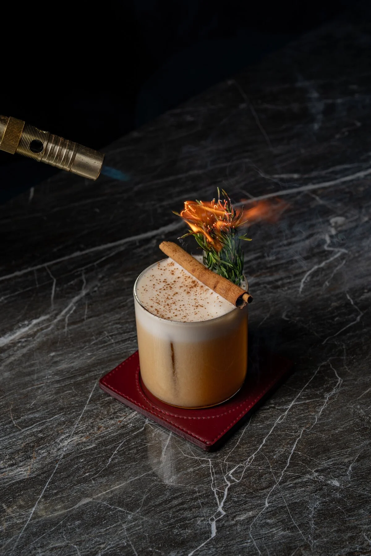Asian Sour cocktail with rosemary being torched at White Rabbit, Uluwatu