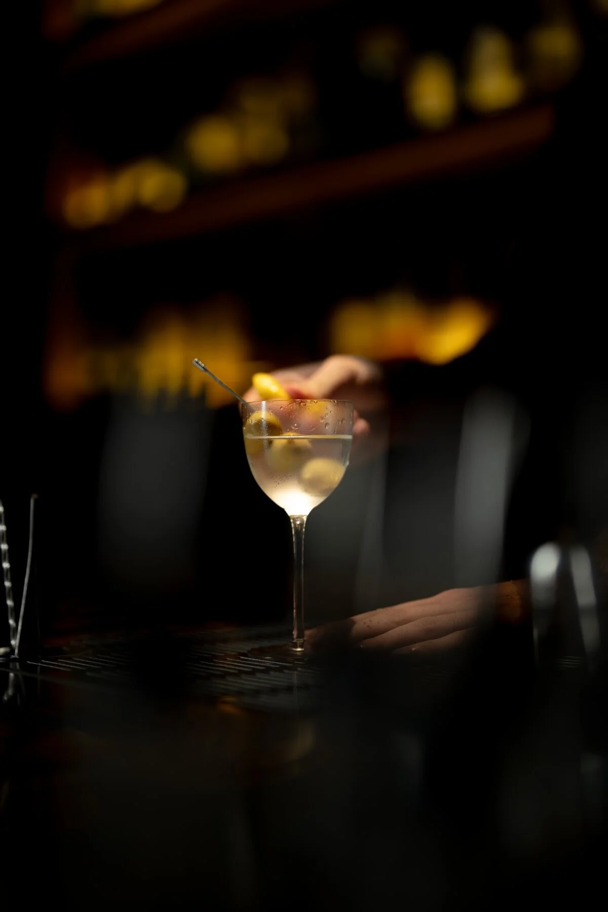 A martini being finished at the bar