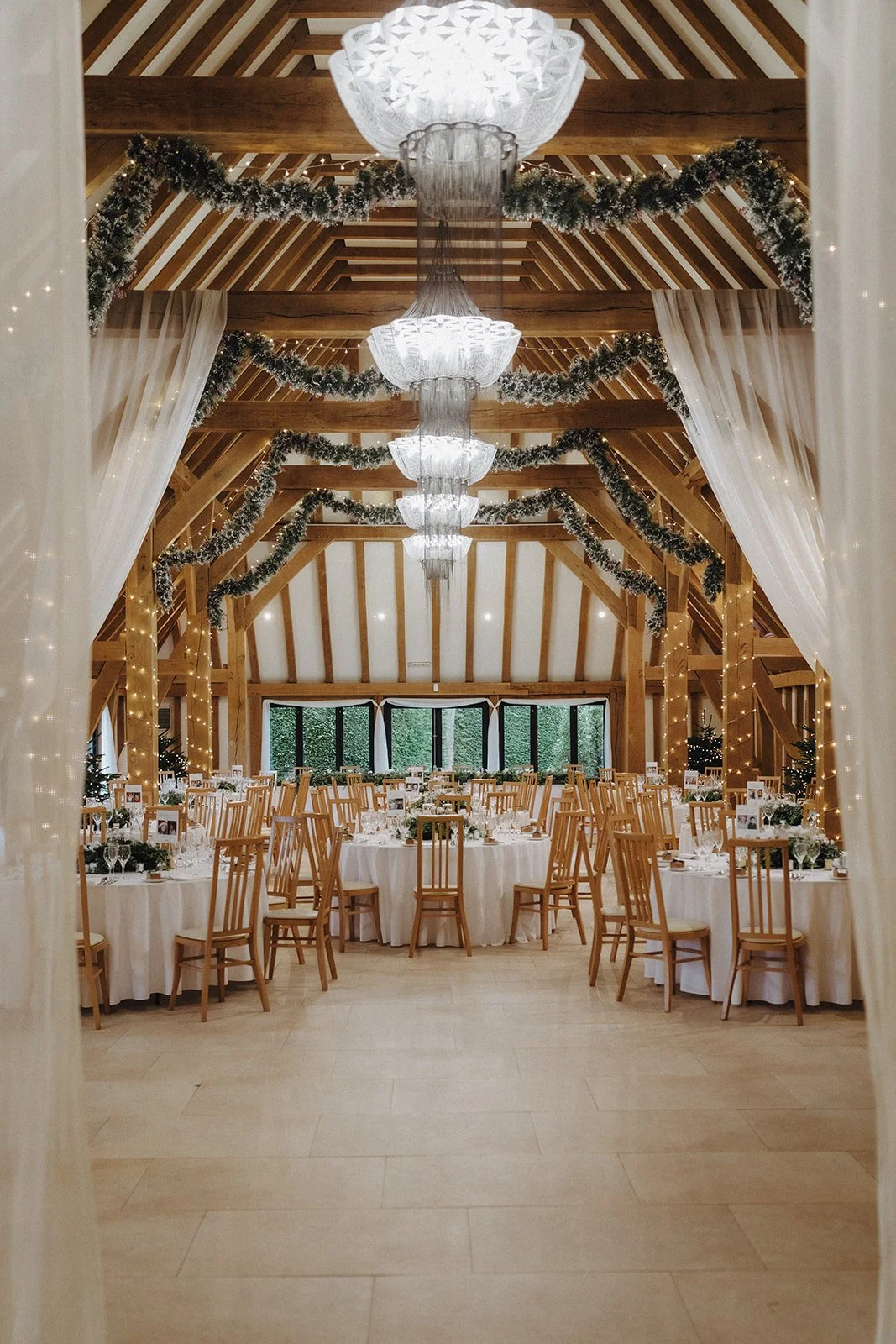 Christmas party venue decorated with fairy lights and fir trees at The Old Kent Barn