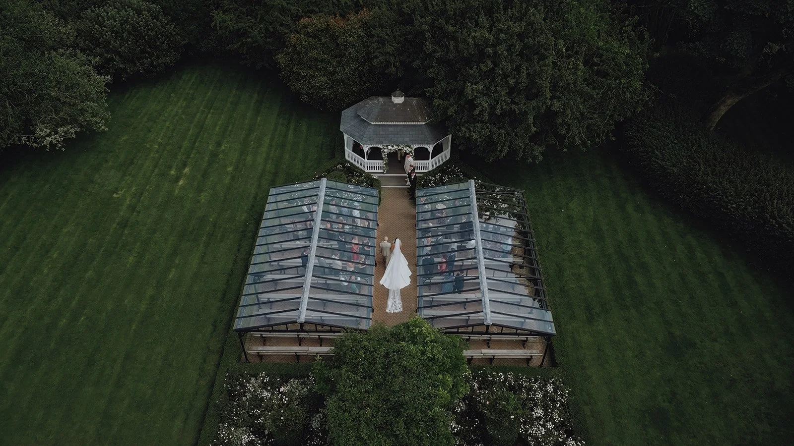 The Old Kent Barn wedding venue aerial of garden ceremony in process