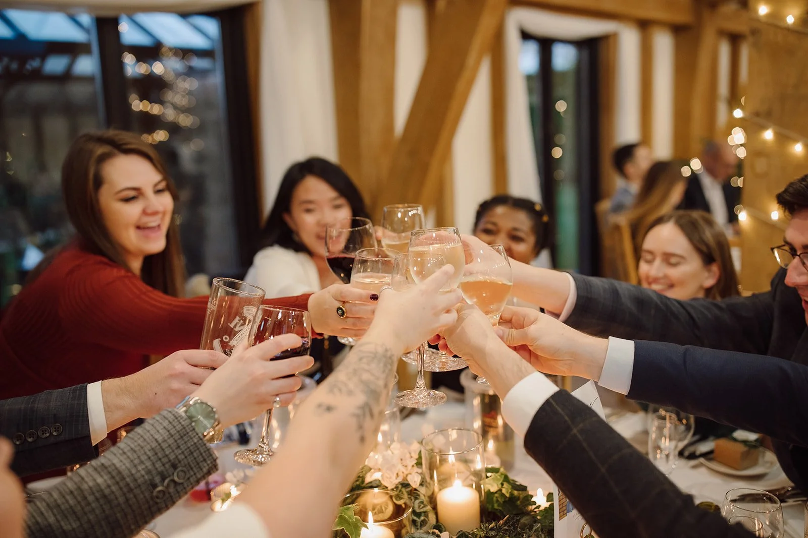 Christmas party at The Old Kent Barn in Kent guests cheers at the table