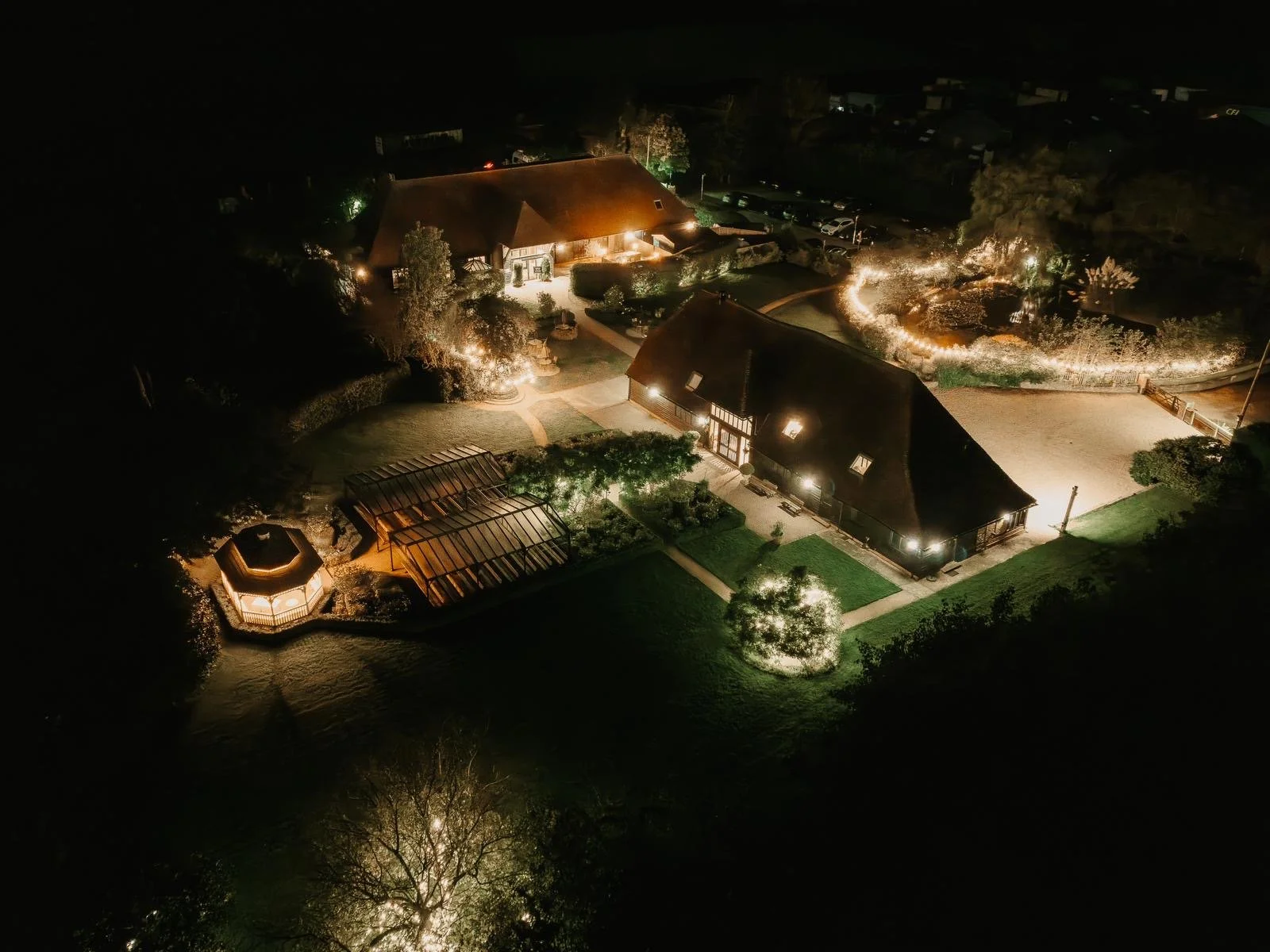 Christmas party venue The Old Kent Barn in Kent illuminated aerial exterior of venue and grounds