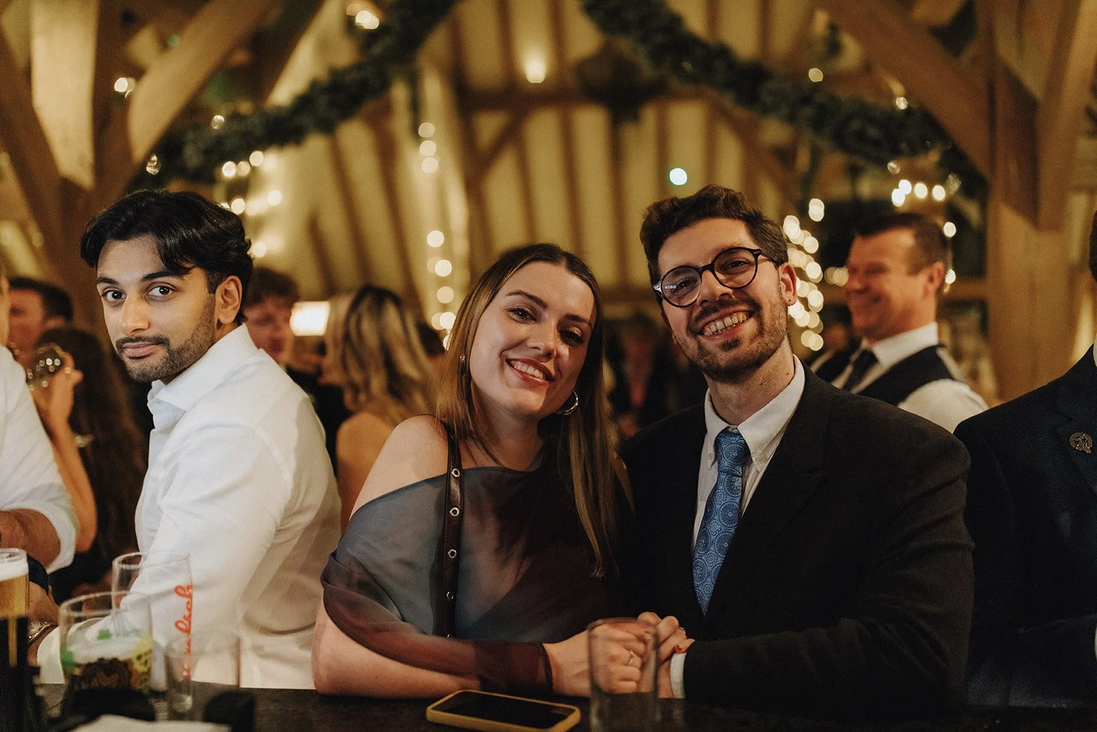 Christmas party at The Old Kent Barn in Kent guests at the bar area with smiles