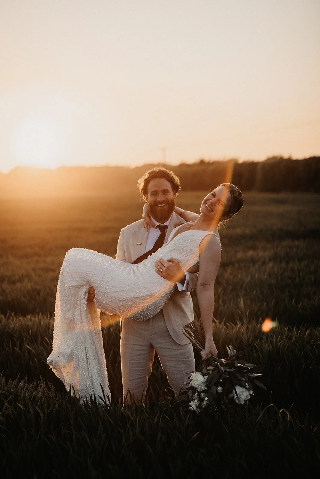 The Old Kent Barn wedding venue golden hour of couple in field