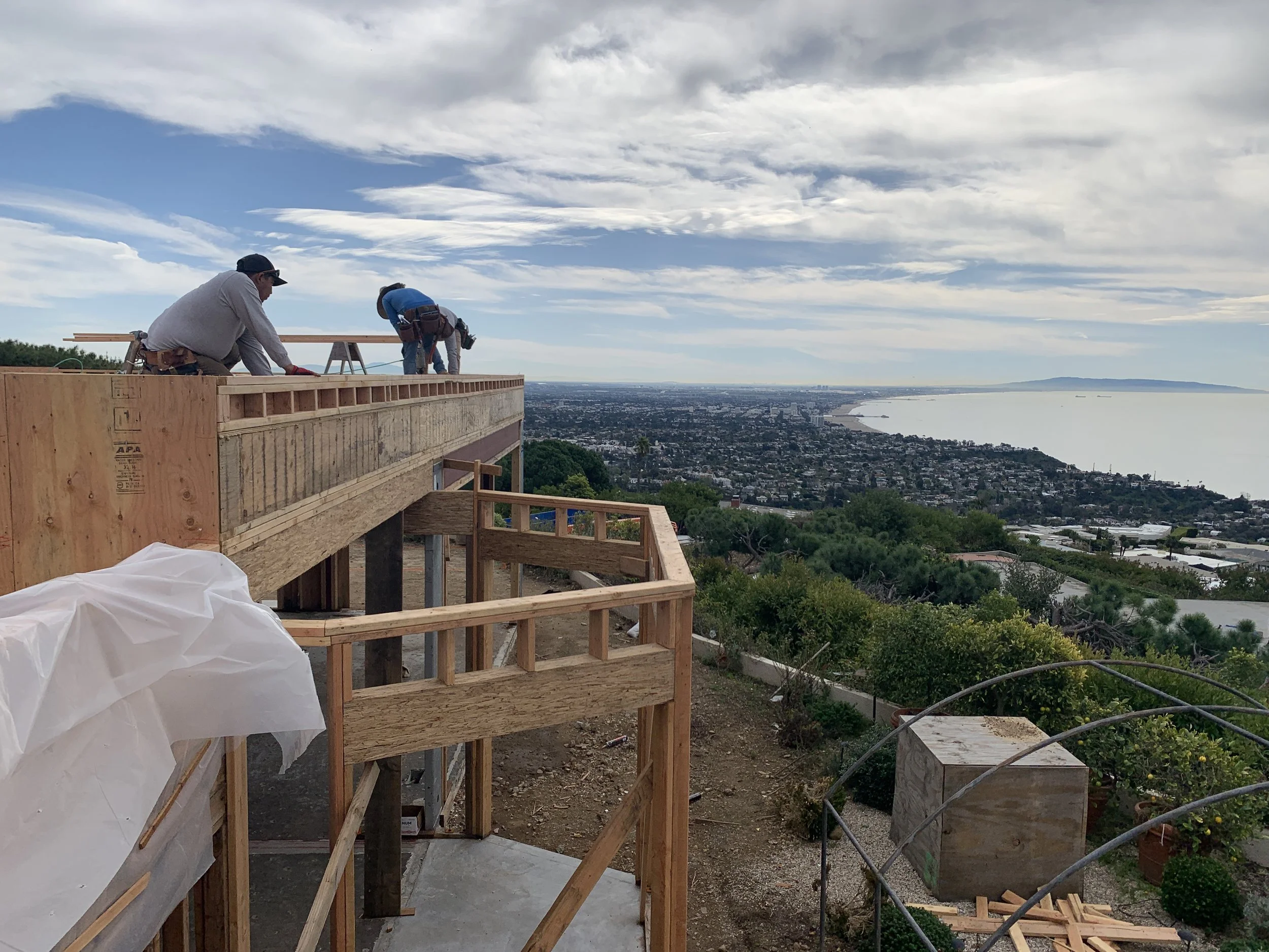 Structural framing underway at the Lachman Lane Residence, overlooking the Pacific coastline from its hillside setting in Pacific Palisades.