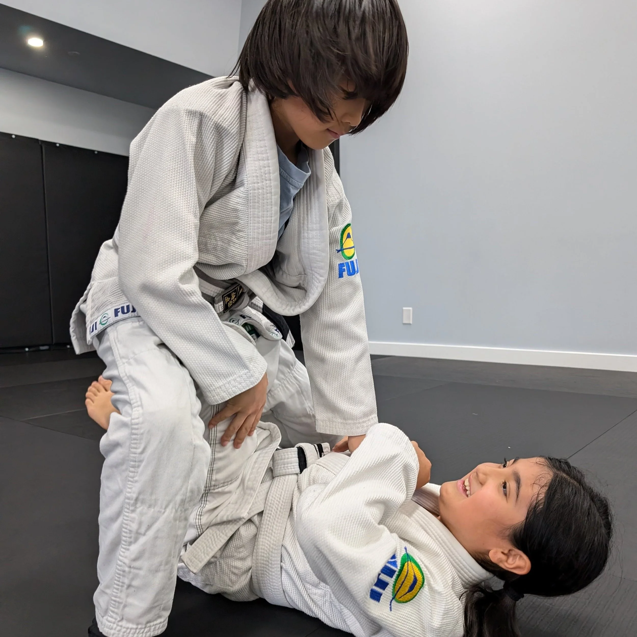 Kids practicing safe BJJ grappling techniques near Downsview Park