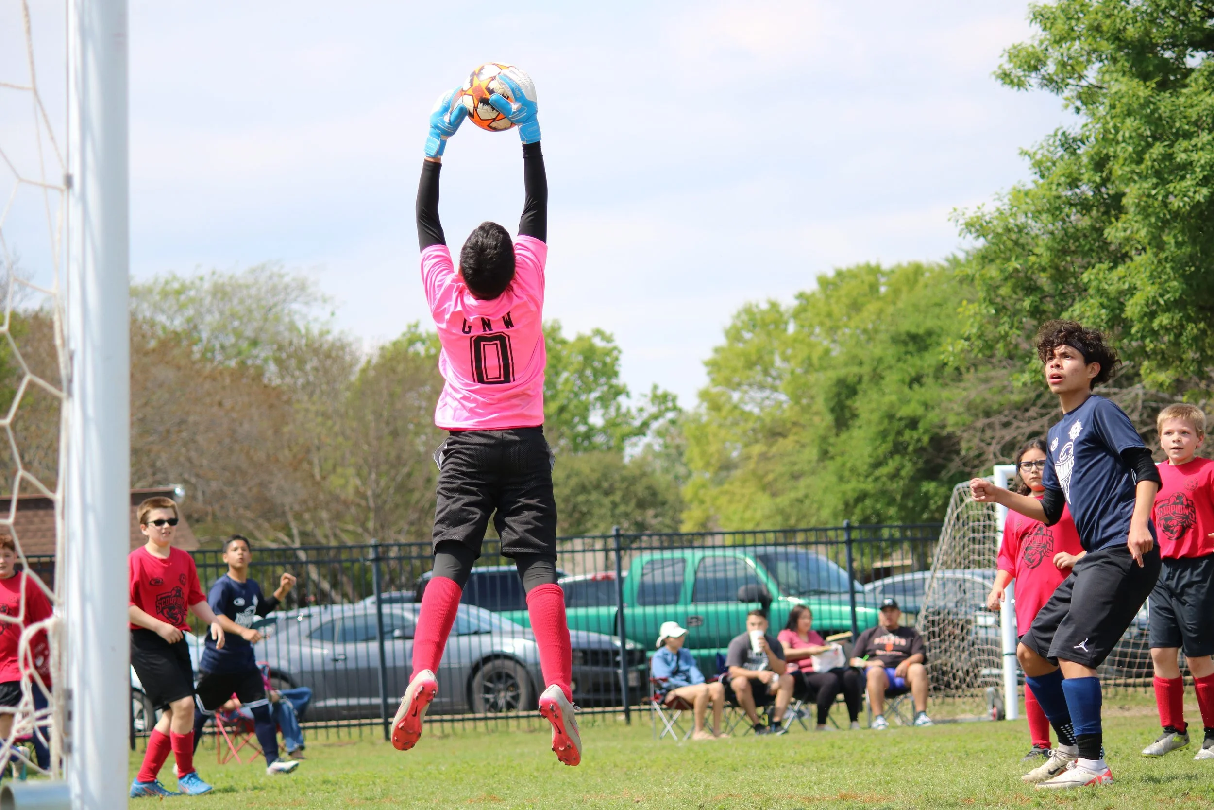 goalie jumping to catch ball