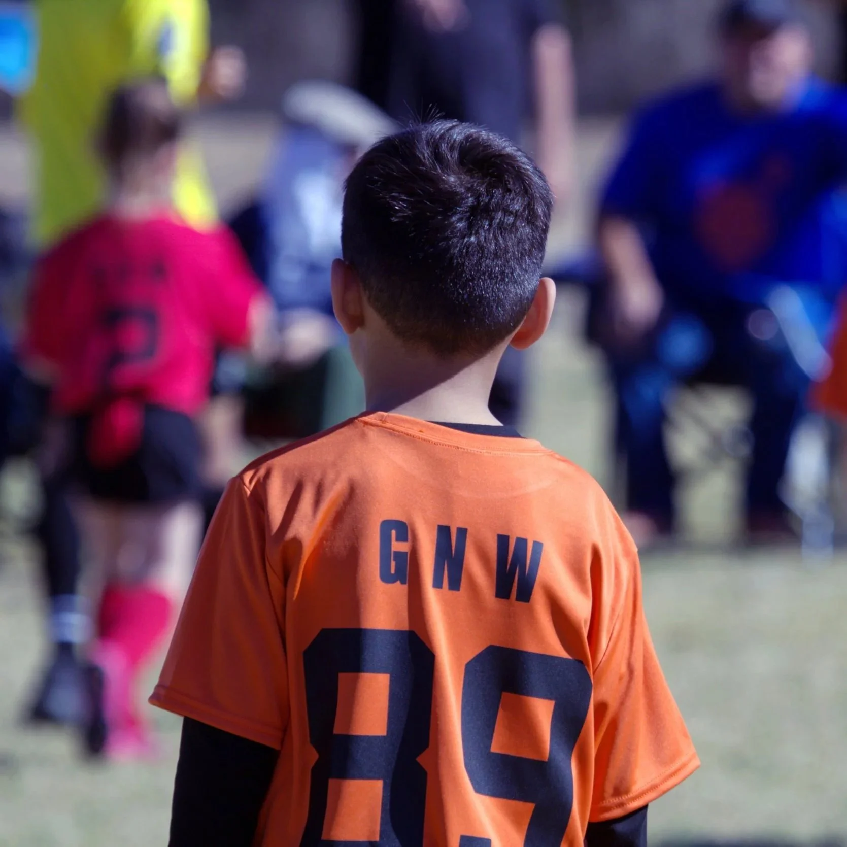 Orange & red little league soccer teams. Photo by Koryna Castro.