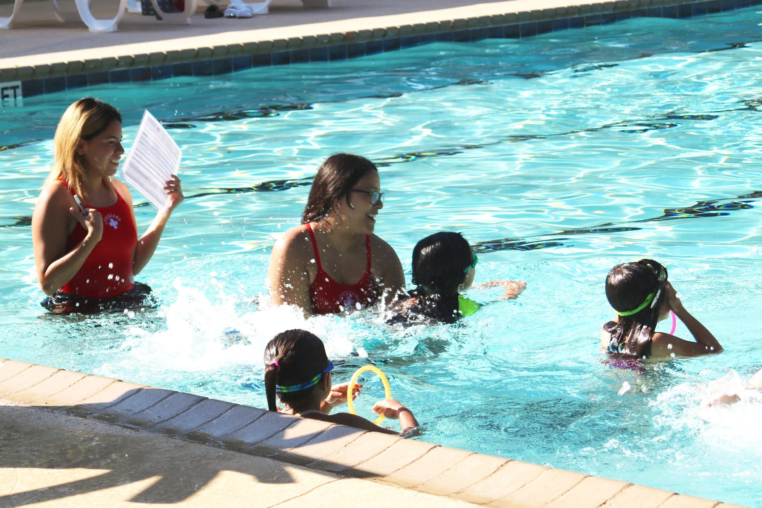 two swim instructors with students