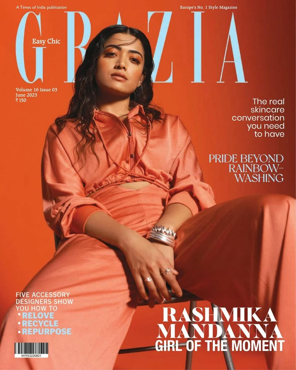 Front cover of Grazia magazine featuring Rashmika Mandanna sitting against a orange background, wearing a peach-colored outfit with jewelry, with headlines about skincare, rainbow-washing, and accessory recycling.