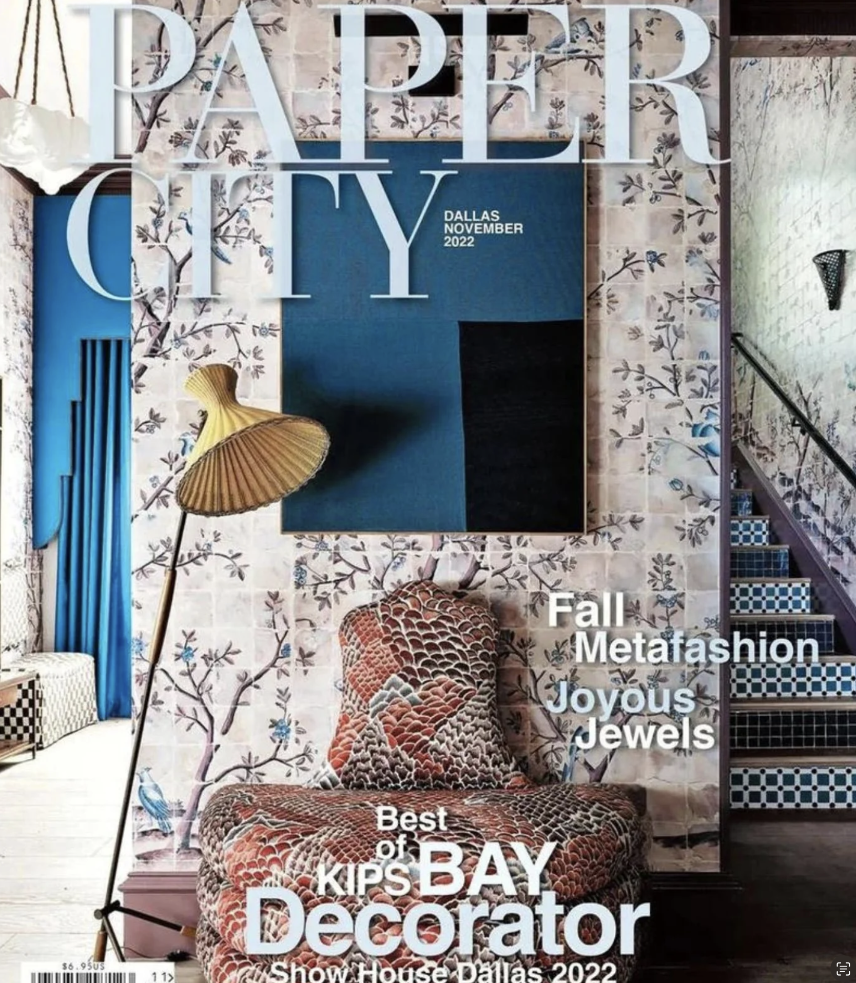 Cover of a magazine titled "Paper City" featuring interior decor with a floral wallpaper wall, a patterned armchair, a blue and black painting, a floor lamp with a yellow shade, and a staircase. The cover mentions Dallas, November 2022, and highlights topics like fall, fashion, jewelry, and interior design.