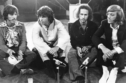 Last night, my husband, Reid, came home from work and insisted that after dinner we turn all the lights off in the house, lie down in the living room, and listen to The End by The Doors in the dark. He said it would be one of the kids&rsquo; first ps