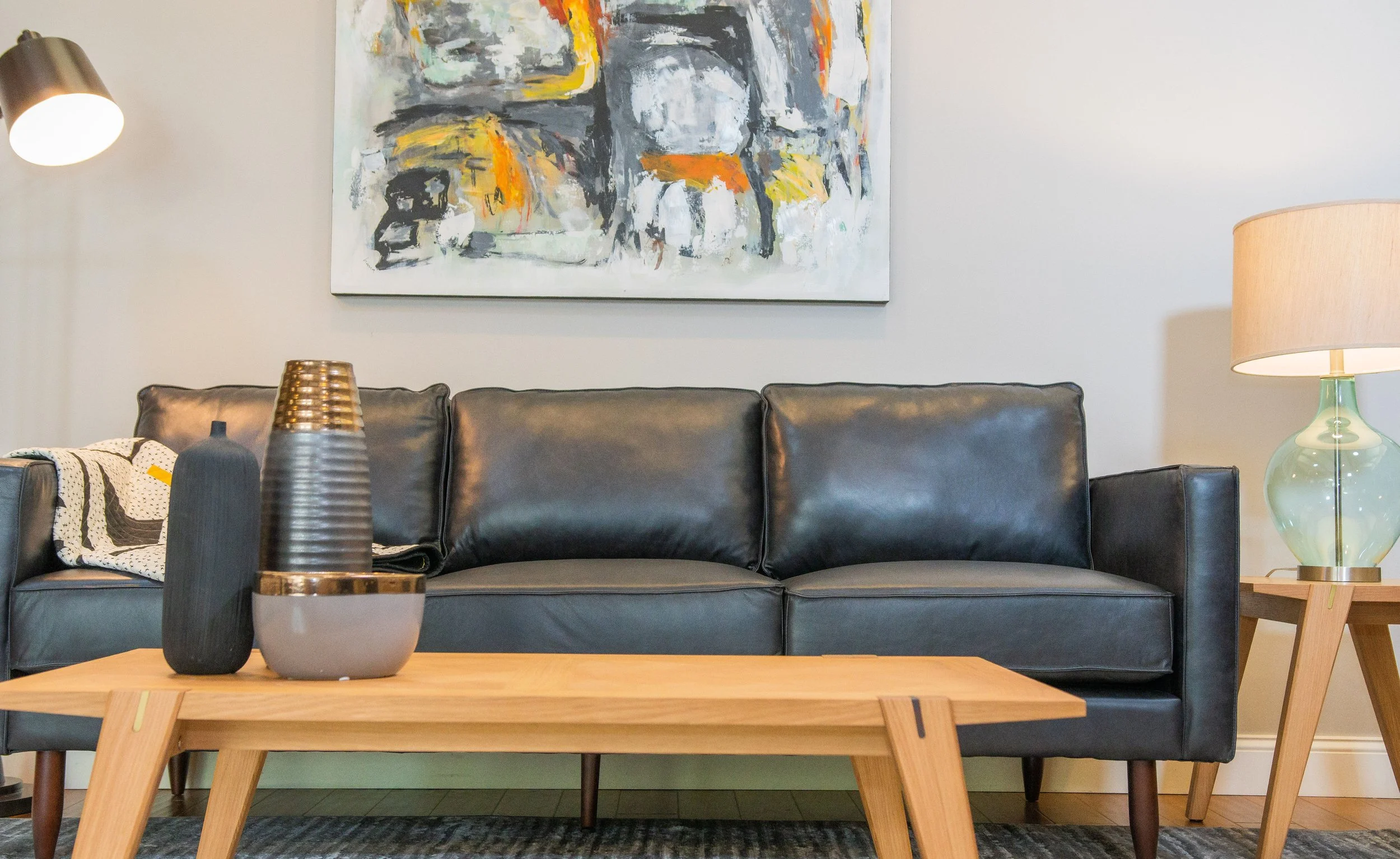 Leather sofa, coffee table and art available for rent at Furniture Options