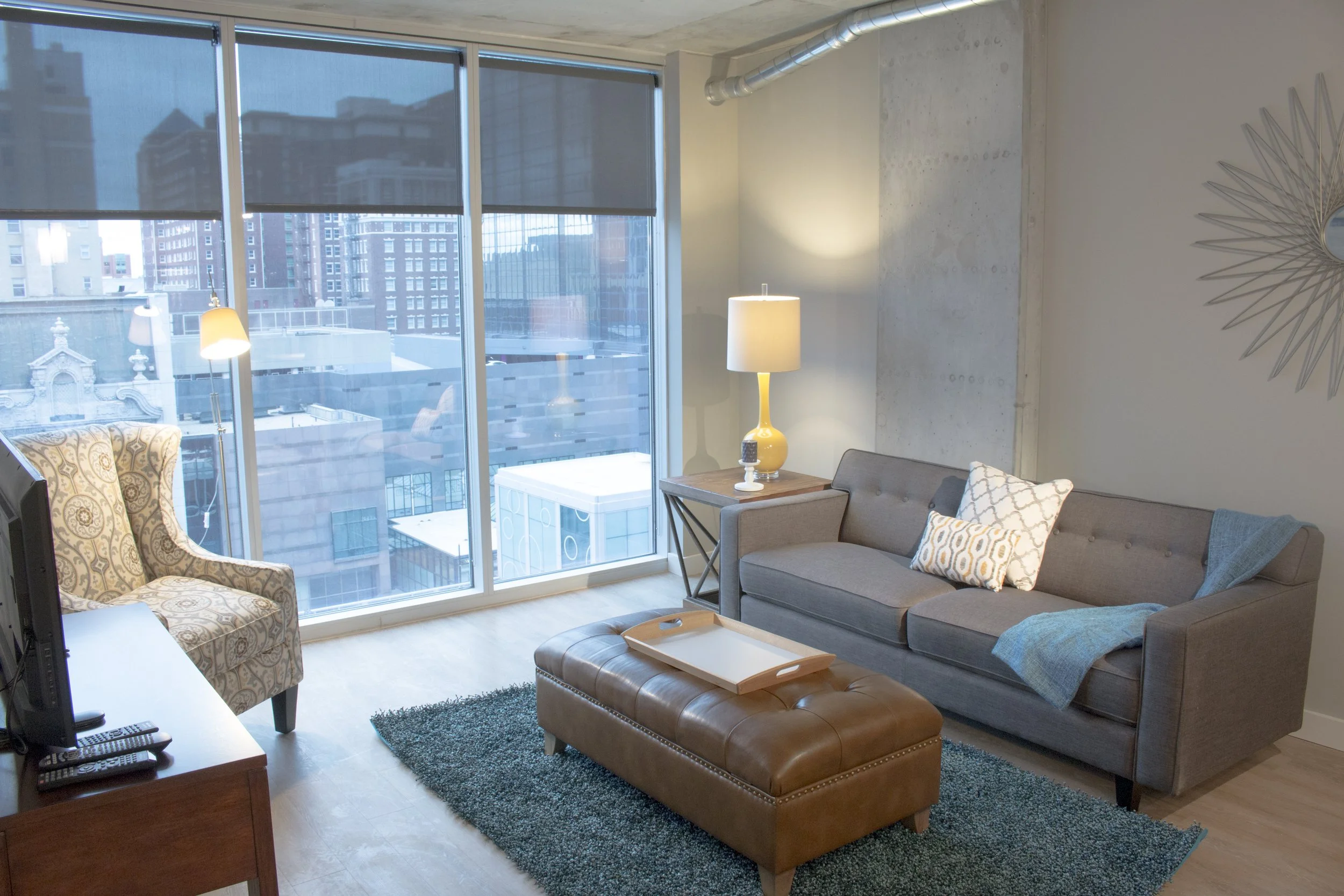 Grey Sofa, ottoman, and chair rented from Furniture Options