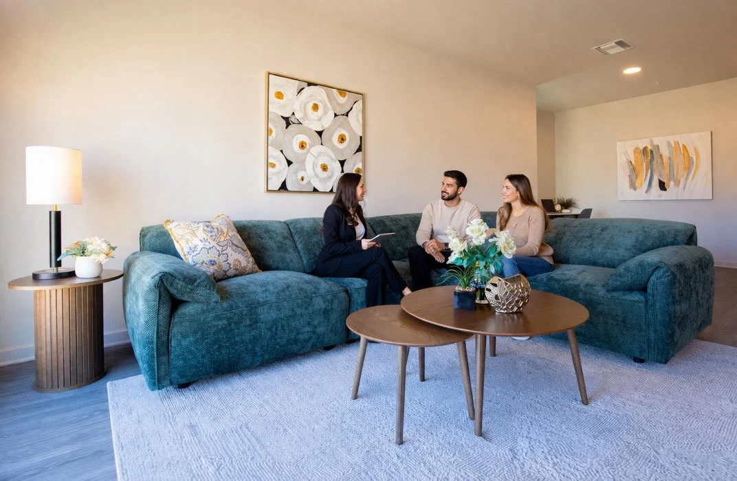 Leasing agent talking to clients in model furnished by Furniture Options