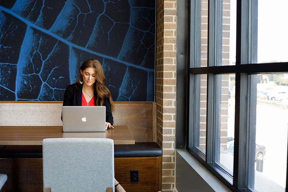 Woman working in apartment common area for Corporate Housing