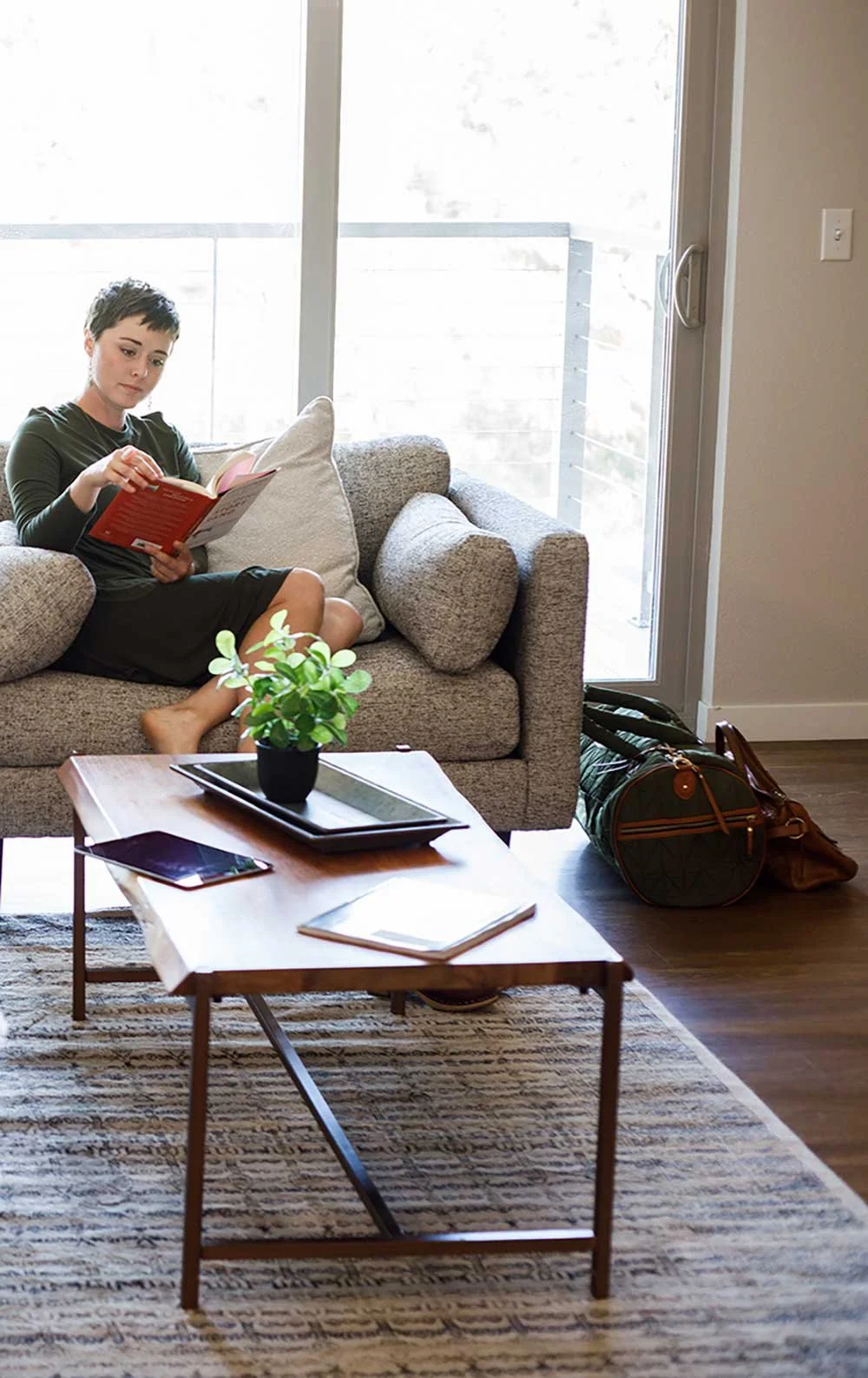Relocation employee in her new corporate apartment with furniture from Furniture Options