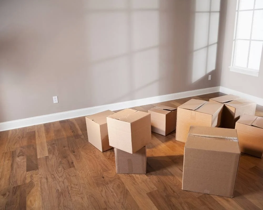 Empty apartment with boxes from a relocated employee in temporary housing.