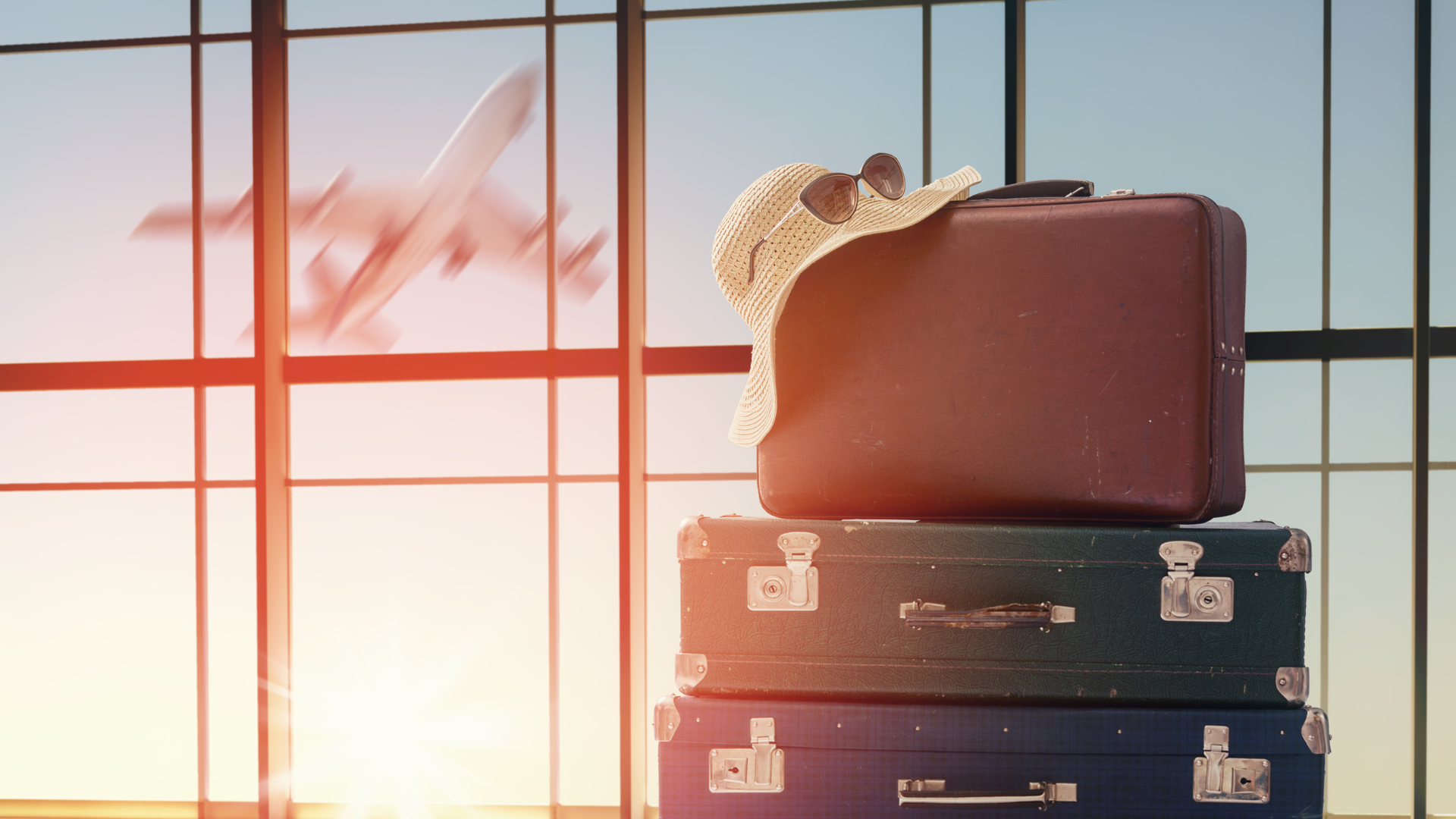pile of suitcases at an airport