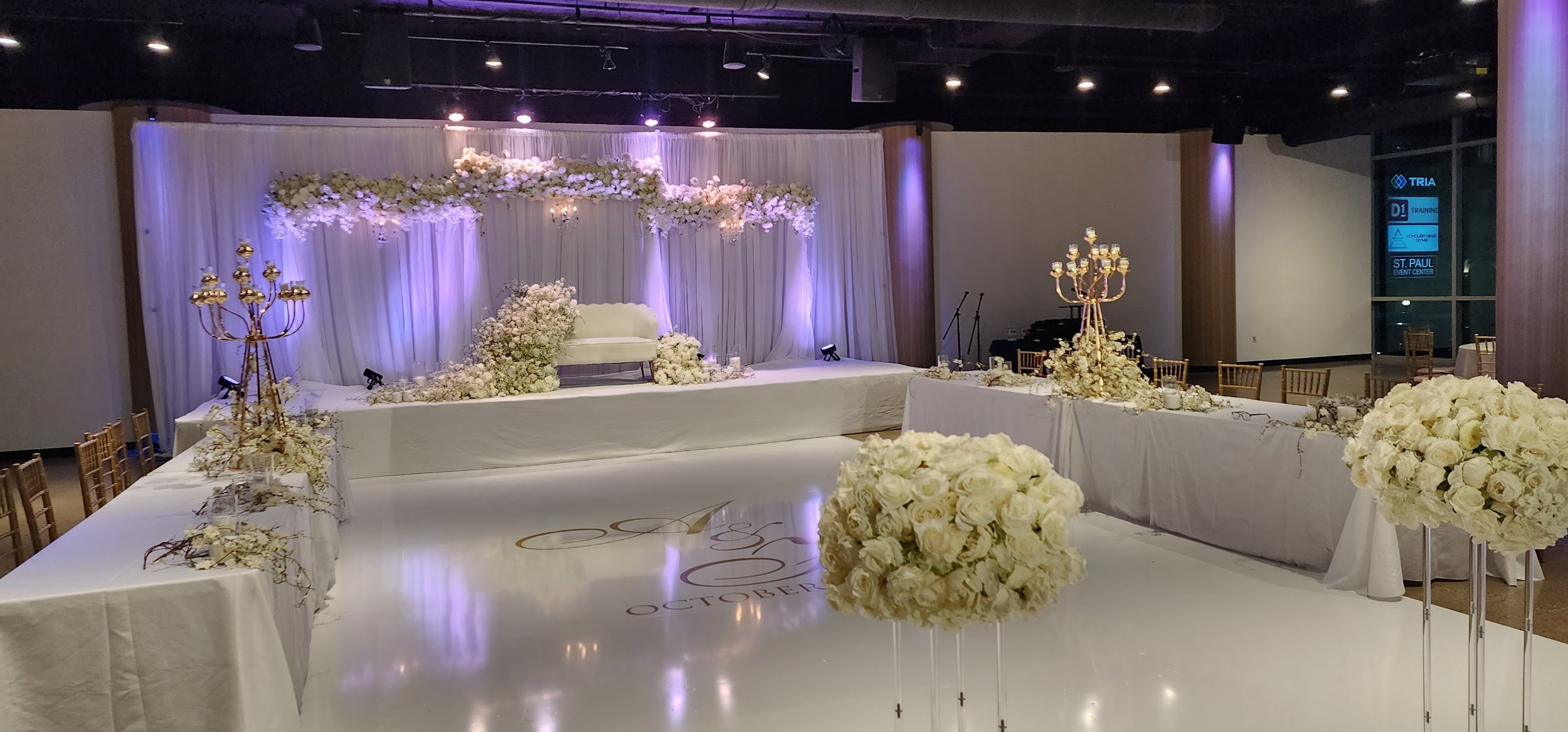 White themed wedding floral head table purple lighting.jpg
