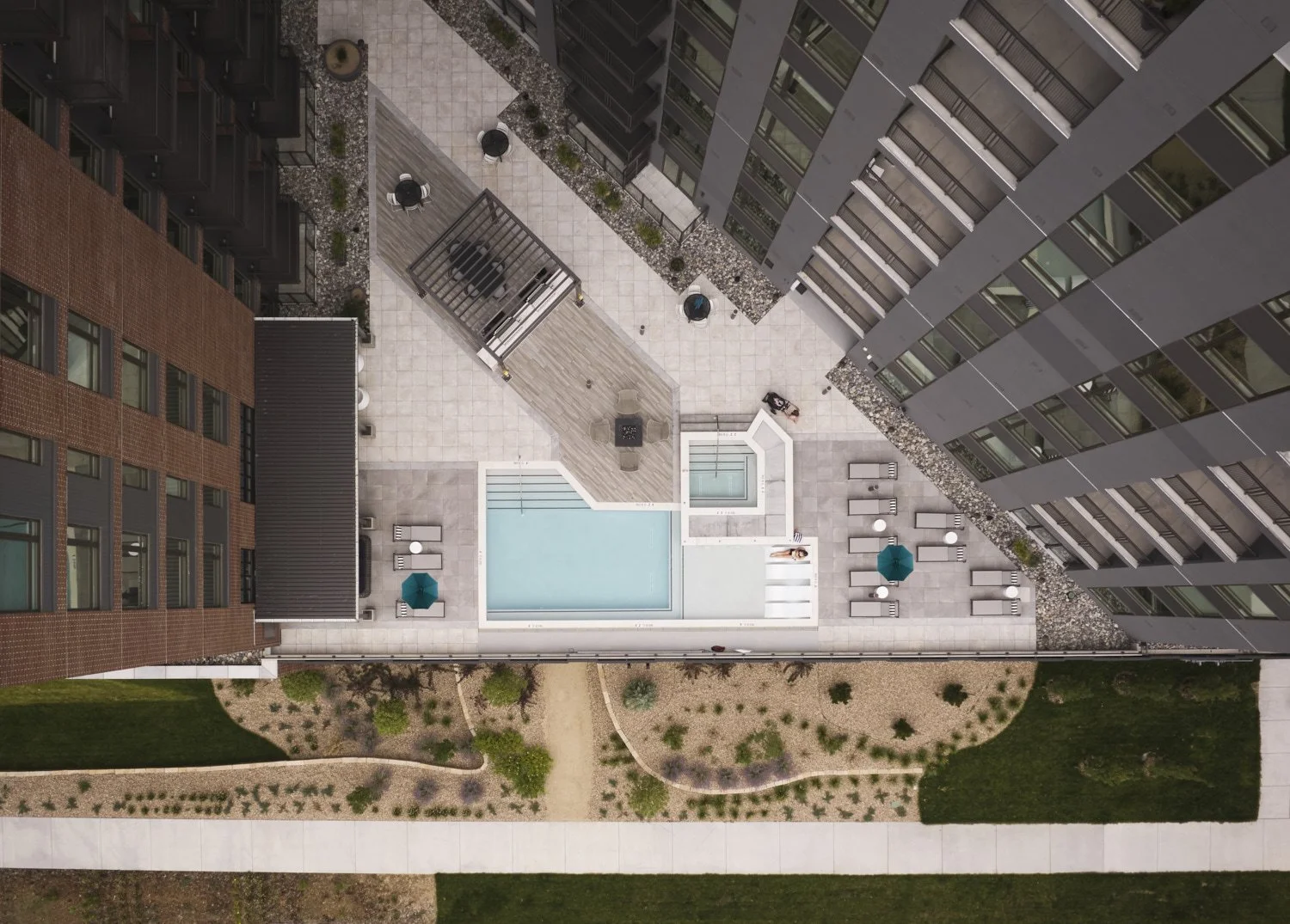 Exterior architectural aerial drone photography by professional photographer Brad Nicol based in Denver, Colorado showing the pool amenity area from above at a multifamily property in Denver.