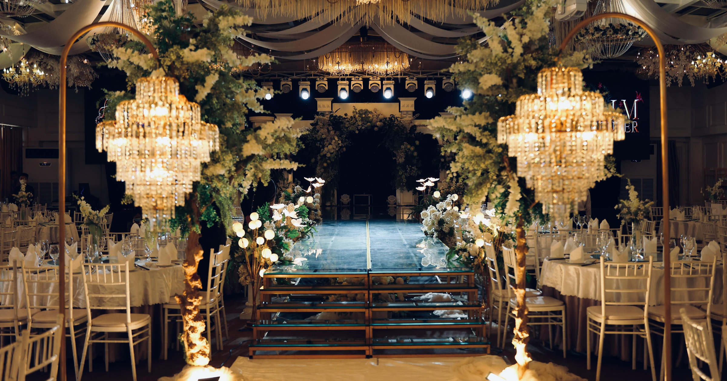 Bespoke event installations with custom florals and architectural elements at a private wedding ceremony.