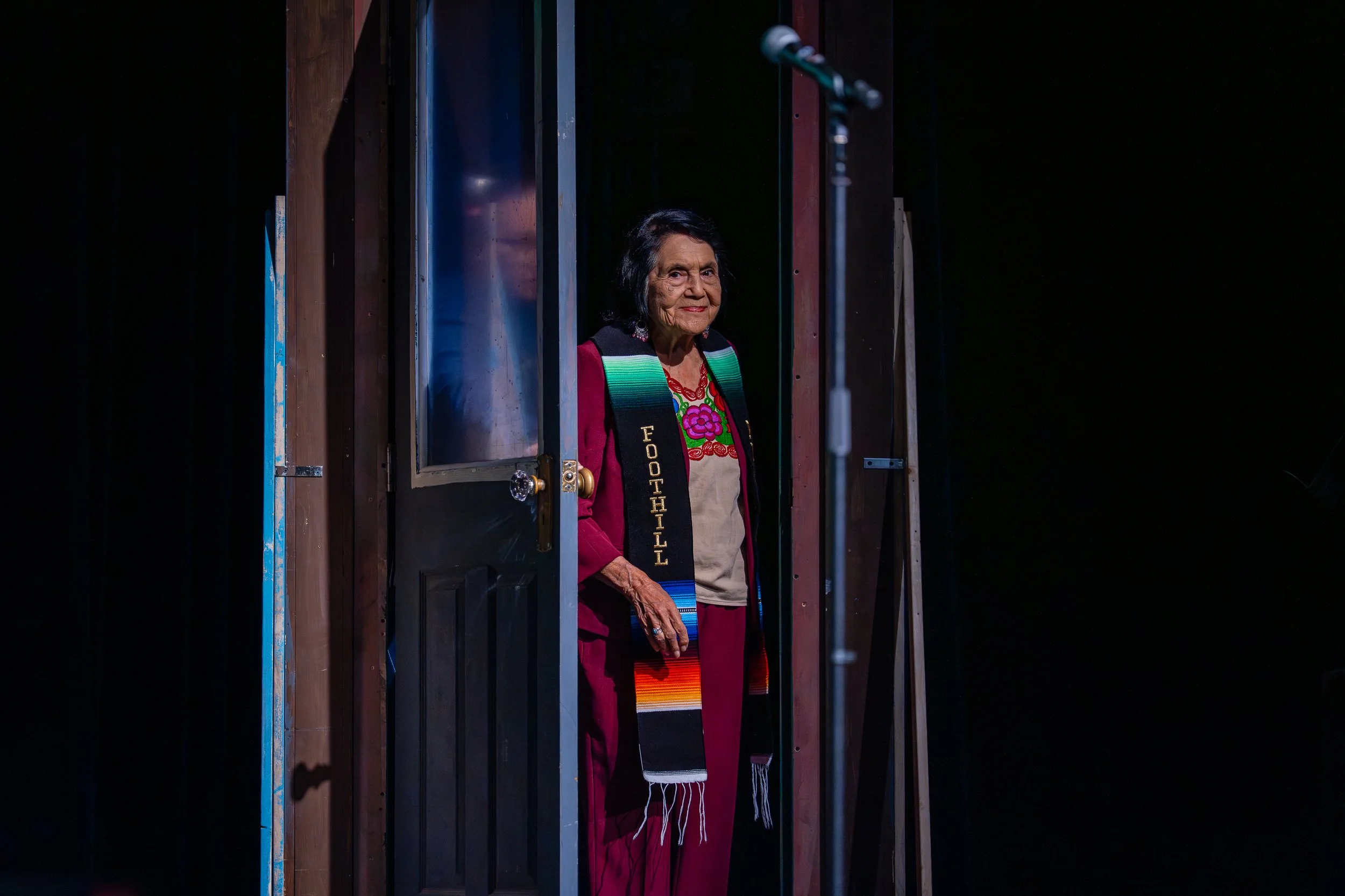Dolores Huerta walks on stage to speak at Foothill College. 