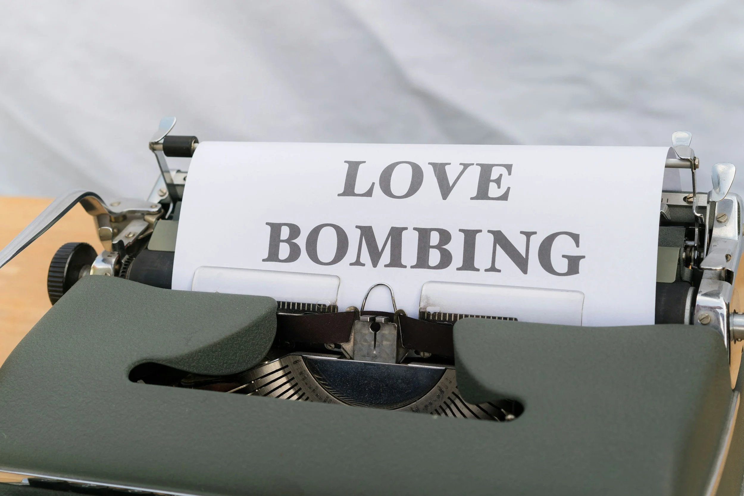 type writer with love bombing in bold letters