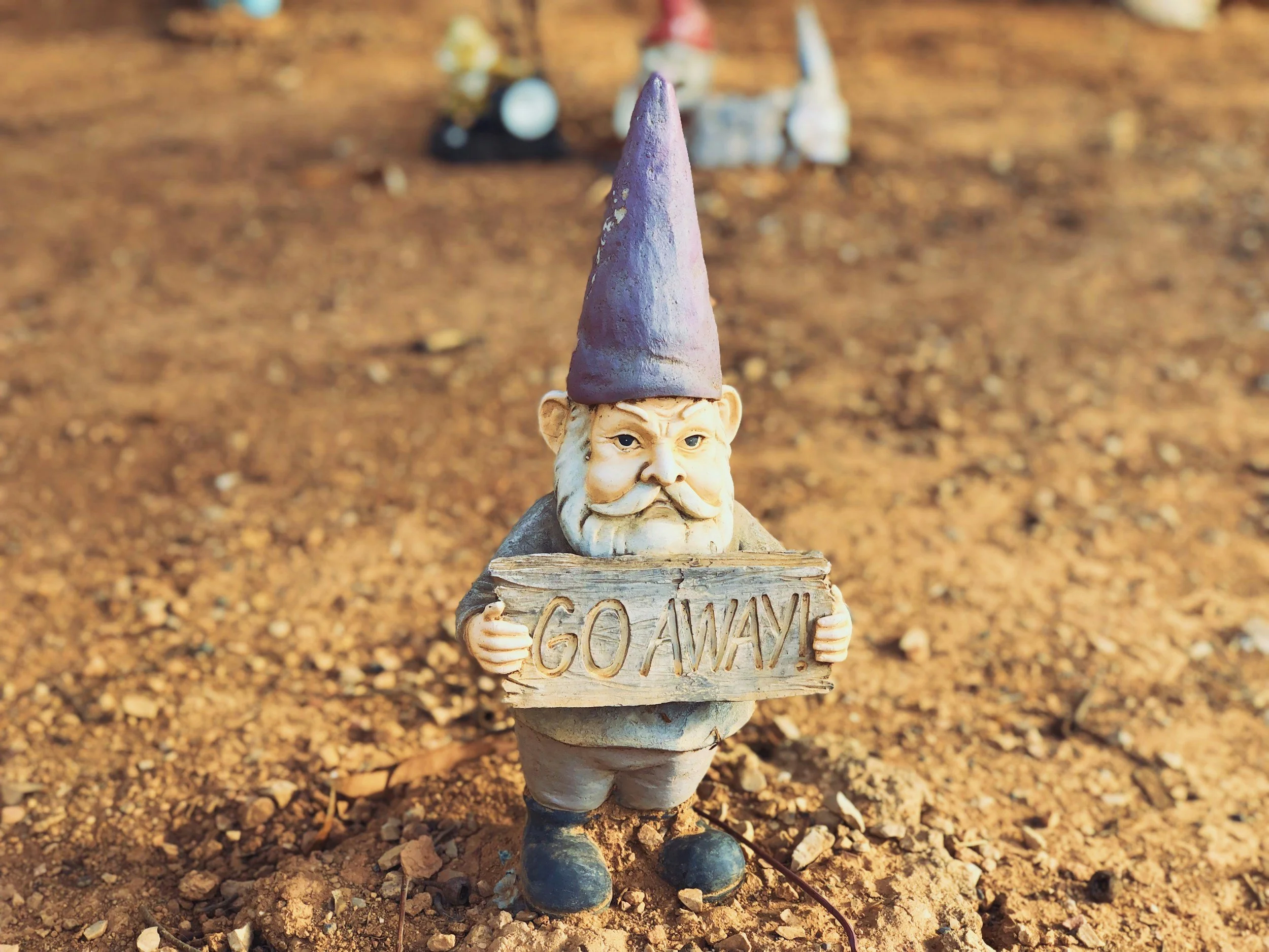 knome holding sign that says Go Away