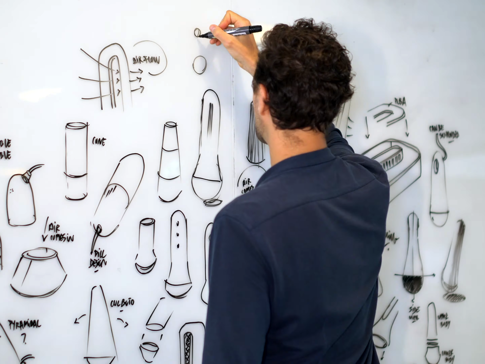 Designer sketching product concepts during feasibility assessment phase