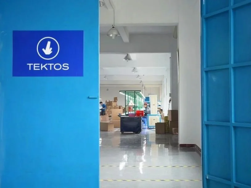 Modern factory interior with TEKTOS branding showing modular manufacturing space