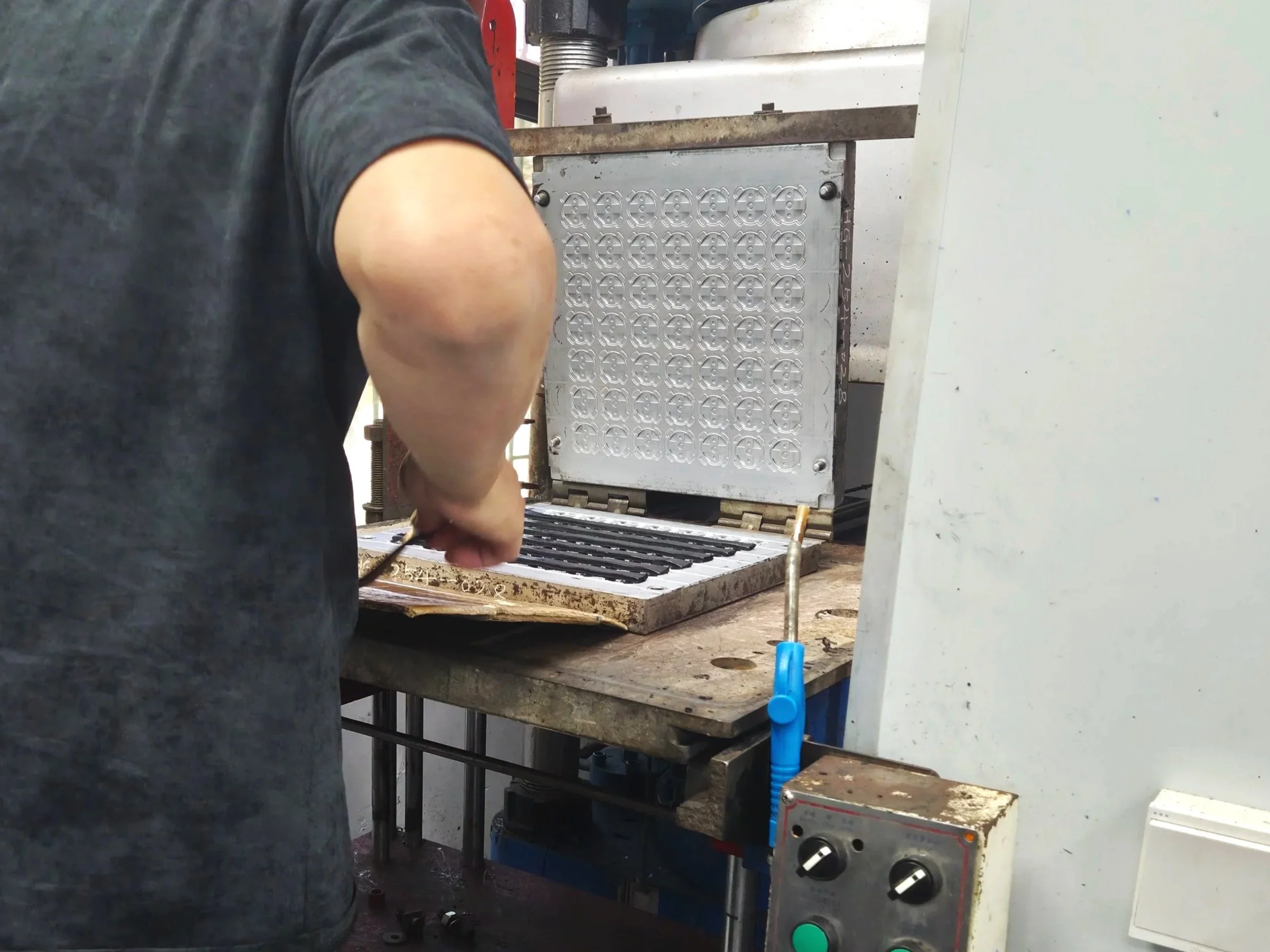 Technician inspecting precision tooling mold for quality control and validation