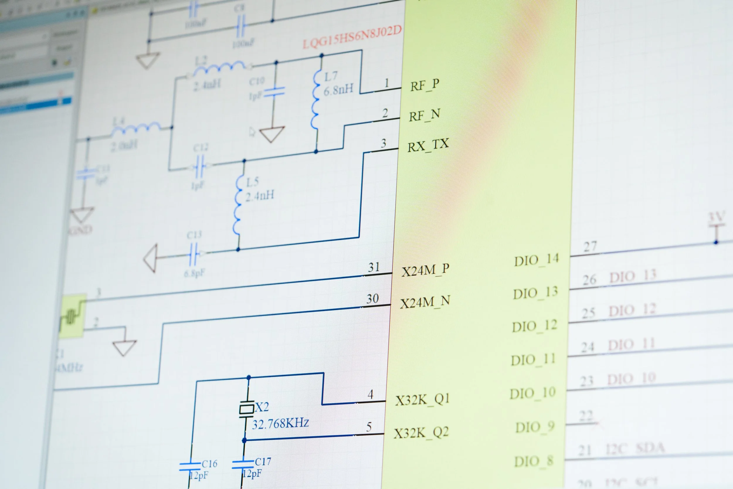 Electronics engineer testing and debugging circuit board at workstation