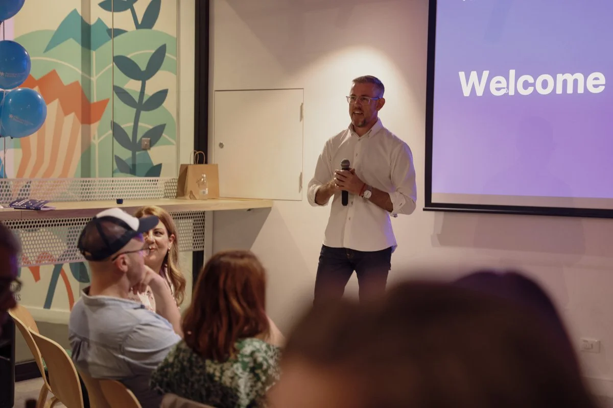 Kris Flegg delivering presentation workshop, speaking to a live audience about presentation design, storytelling, and business communication.