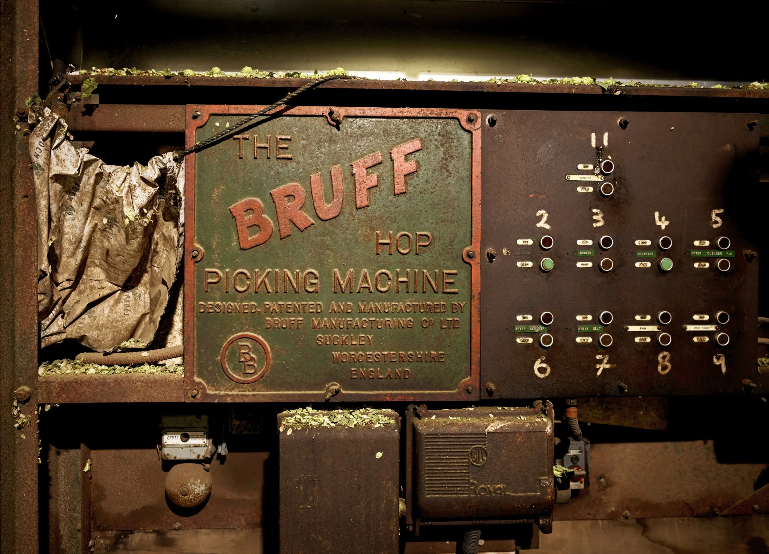 Control panel of a vintage 'Bruff' hop picking machine with labeled buttons and switches.