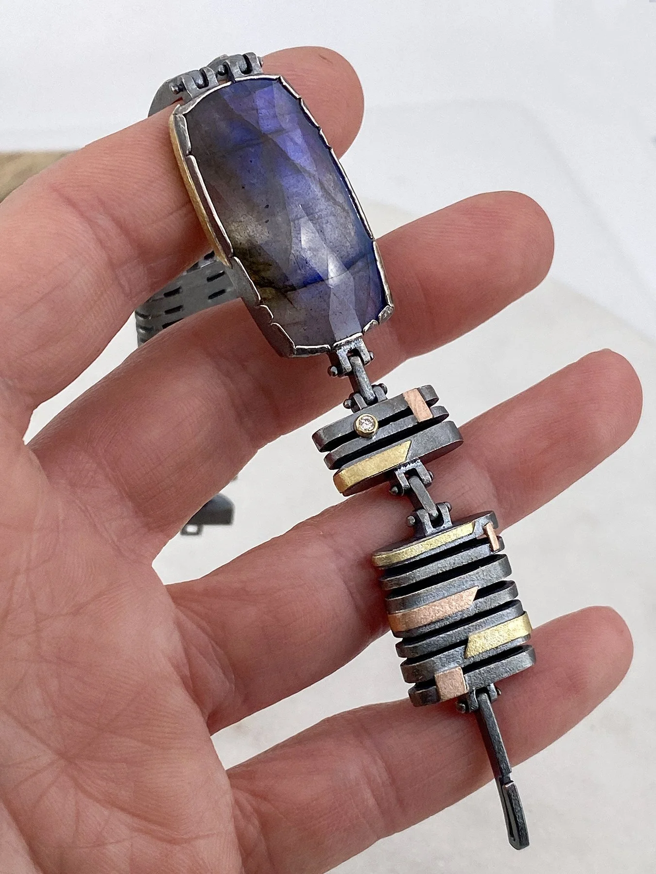 Labradorite and Diamond Banded Hinged Bracelet holding.jpg