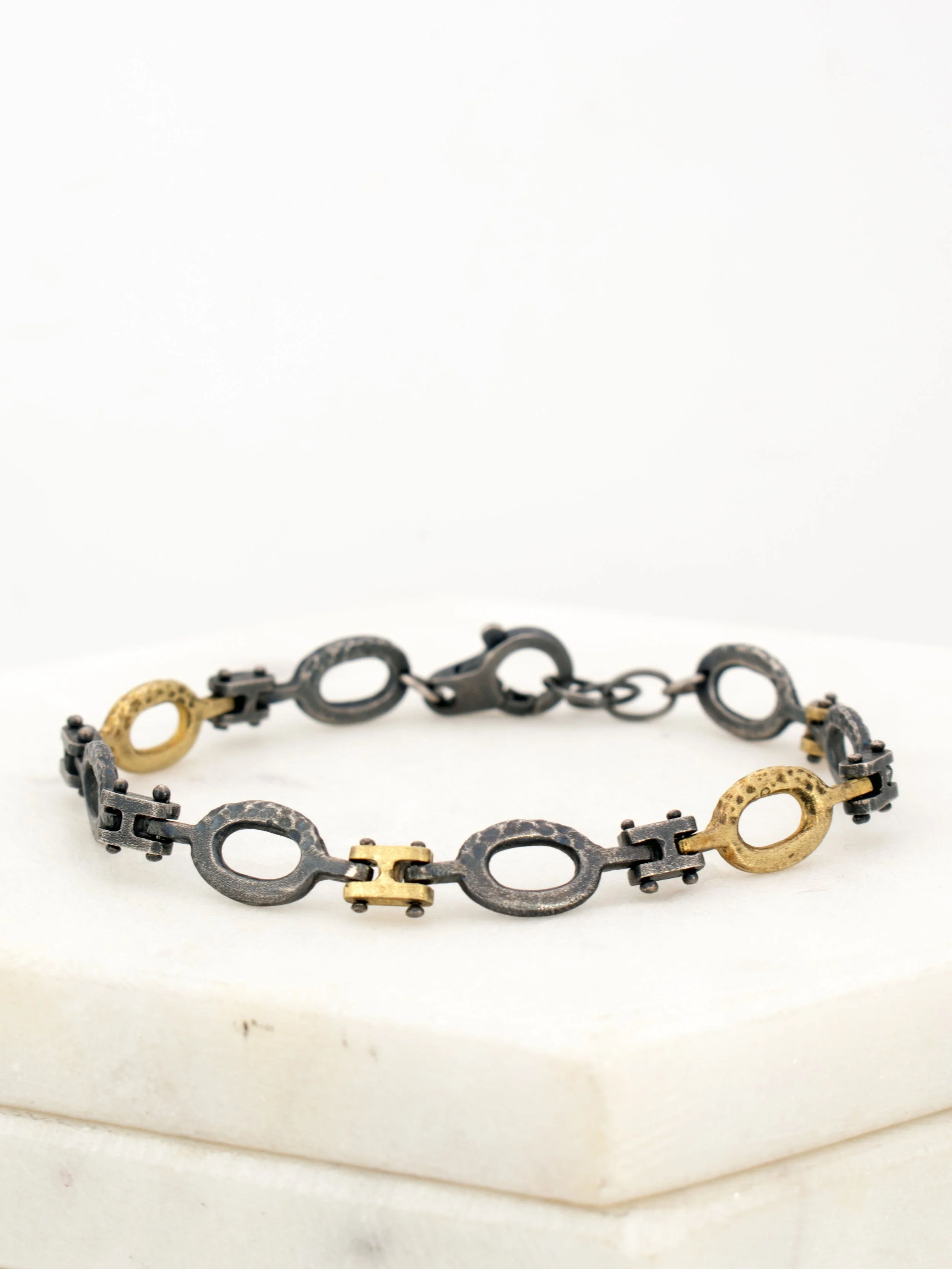 Textured Hinged Bracelet with silver and yellow gold links 1.jpg