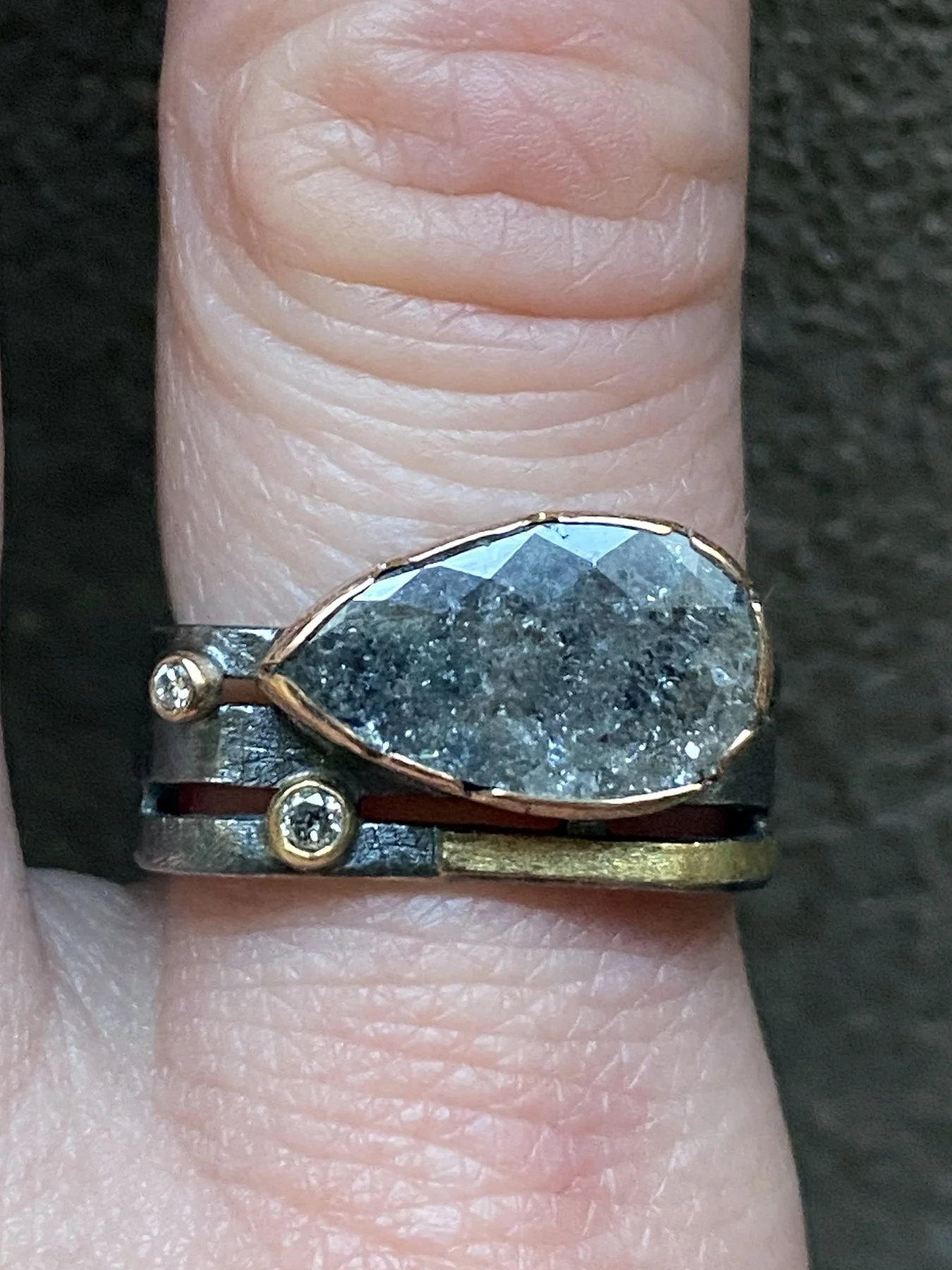 Pear Grey Diamond and 2 round diamonds on a Triple Band Square Ring on.jpg