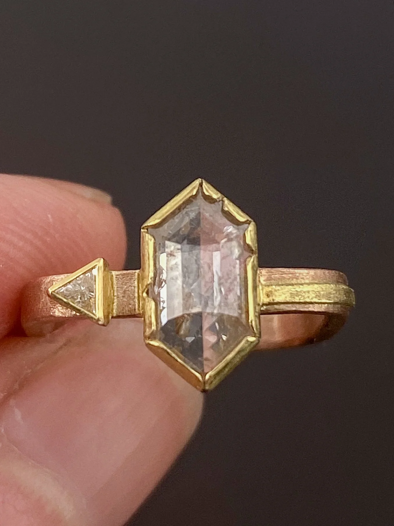 Trapezoid Rose Cut Diamond and Triangle Diamond on a Rose Gold Square Band holding 2.jpg
