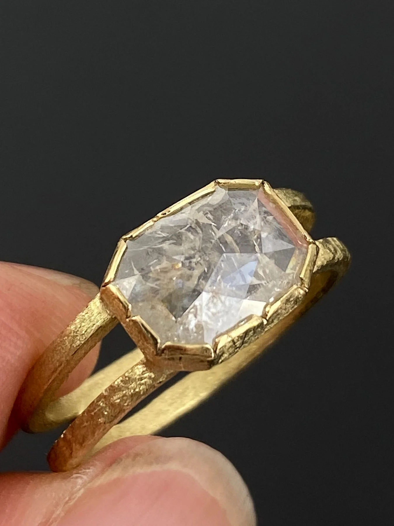 Fancy Cut Rectangle Diamond on a Double Band Textured Round Ring holding.jpg