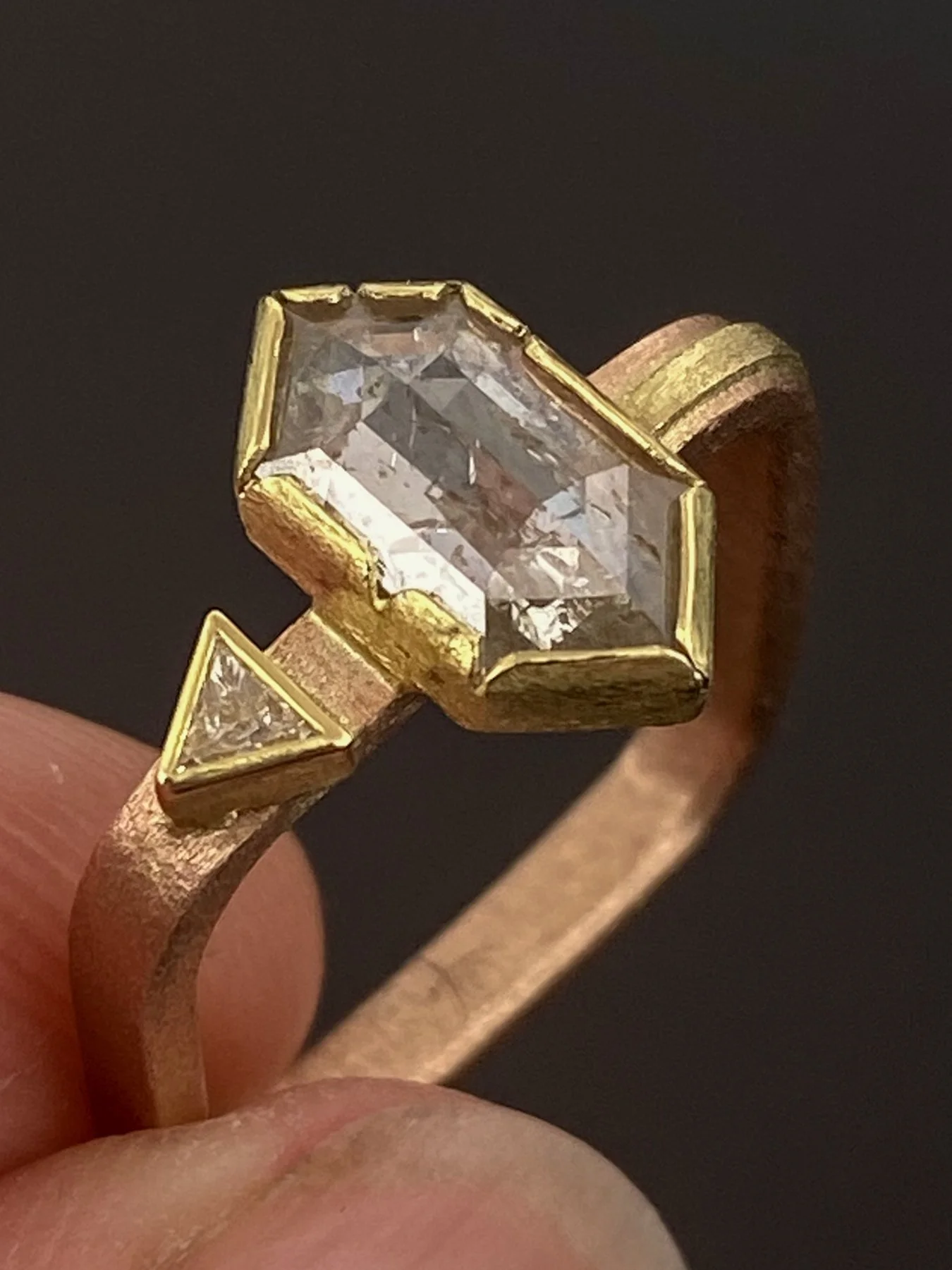 Trapezoid Rose Cut Diamond and Triangle Diamond on a Rose Gold Square Band holding.jpg