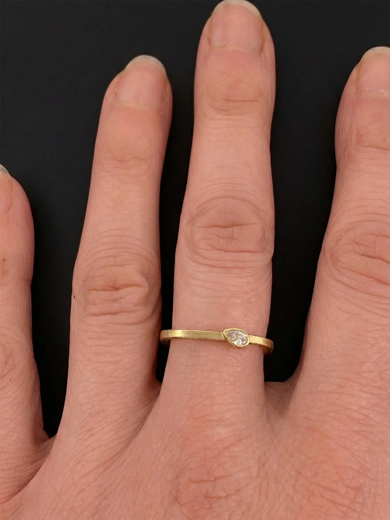Pear Diamond on Gold Square Band on hand.jpg