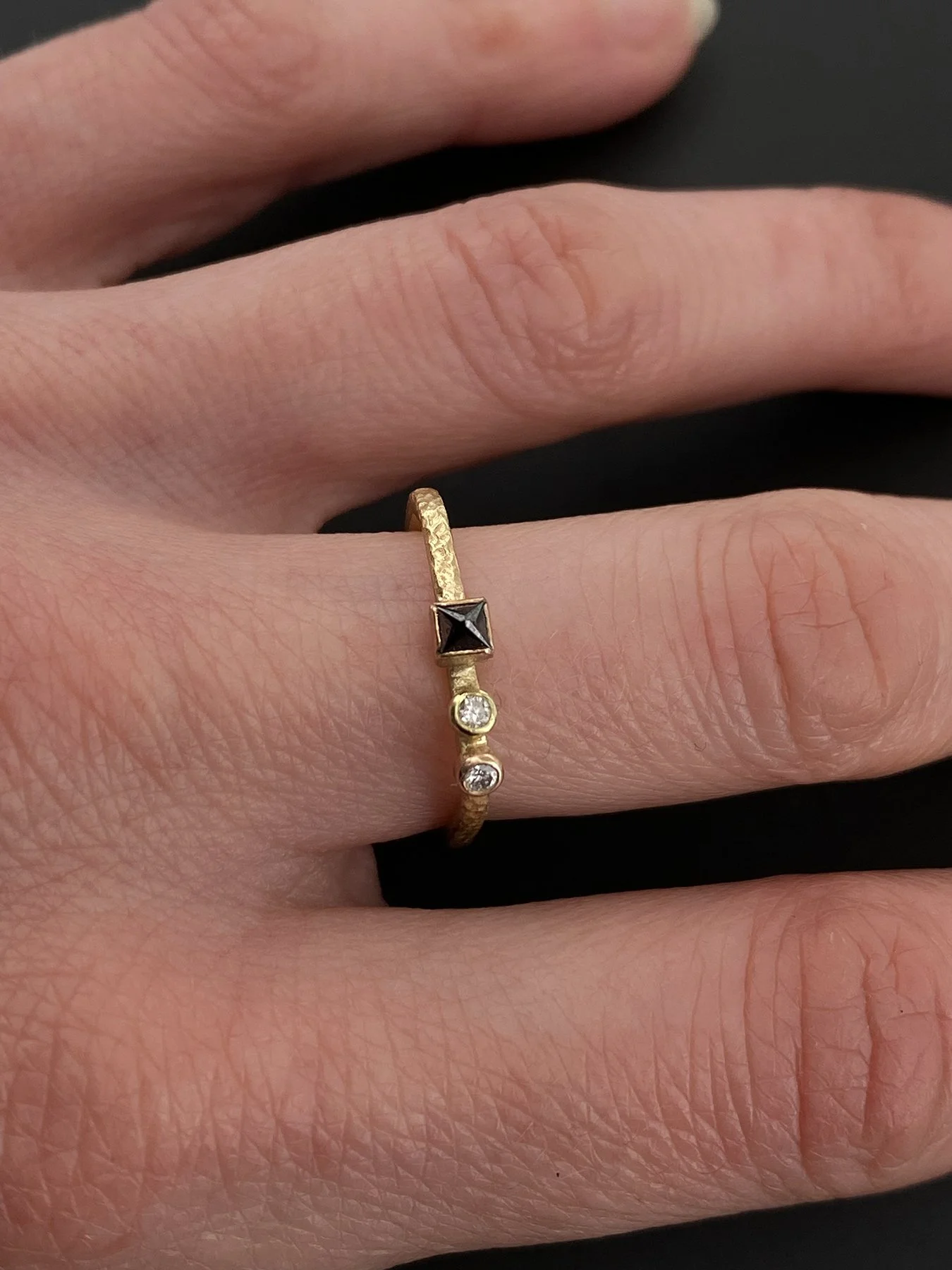 Square Black Diamond and Two Round White Diamonds on a Gradient Yellow-Rose Gold Square Band on hand 1.jpg