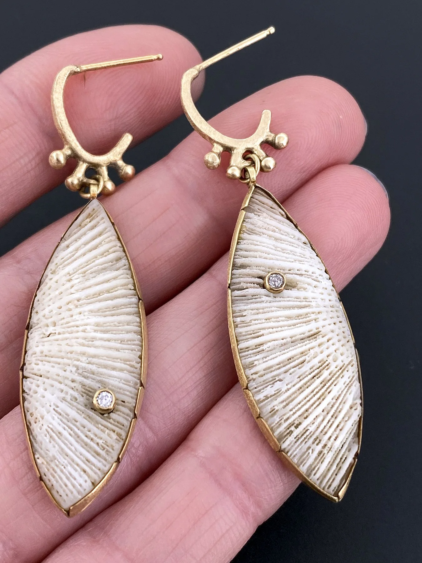Vintage Coral Ellipse with Diamond on Nub Post Earring holding.jpg