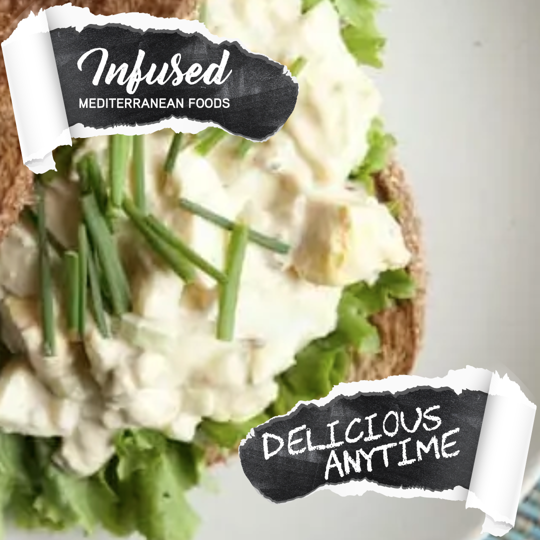 Close-up of a sandwich with lettuce, cheese, and green onions, with decorative black and white labels reading 'Infused Mediterranean Foods' and 'Delicious Anytime'.