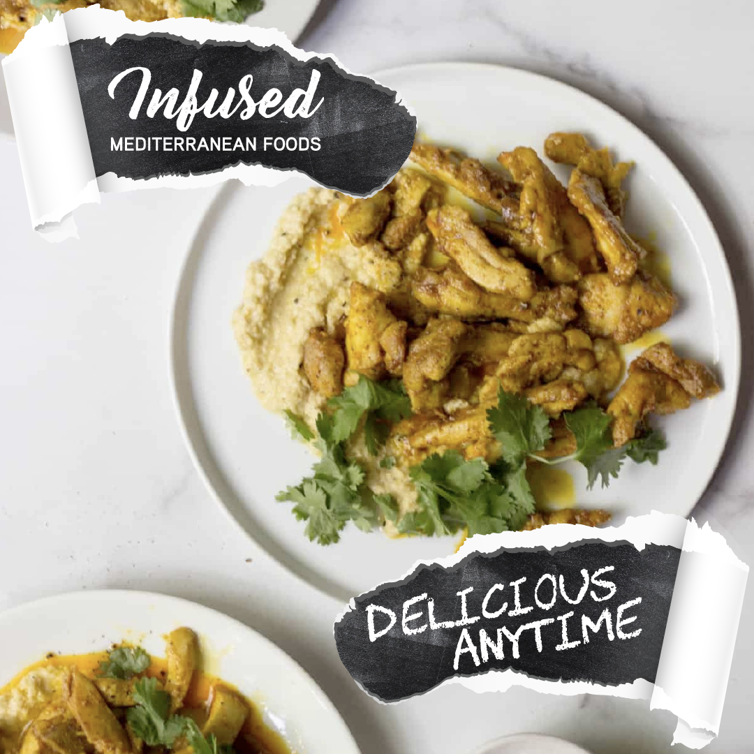 Plate of seasoned fried chicken garnished with cilantro, served with a side of creamy mashed potatoes and vegetables.