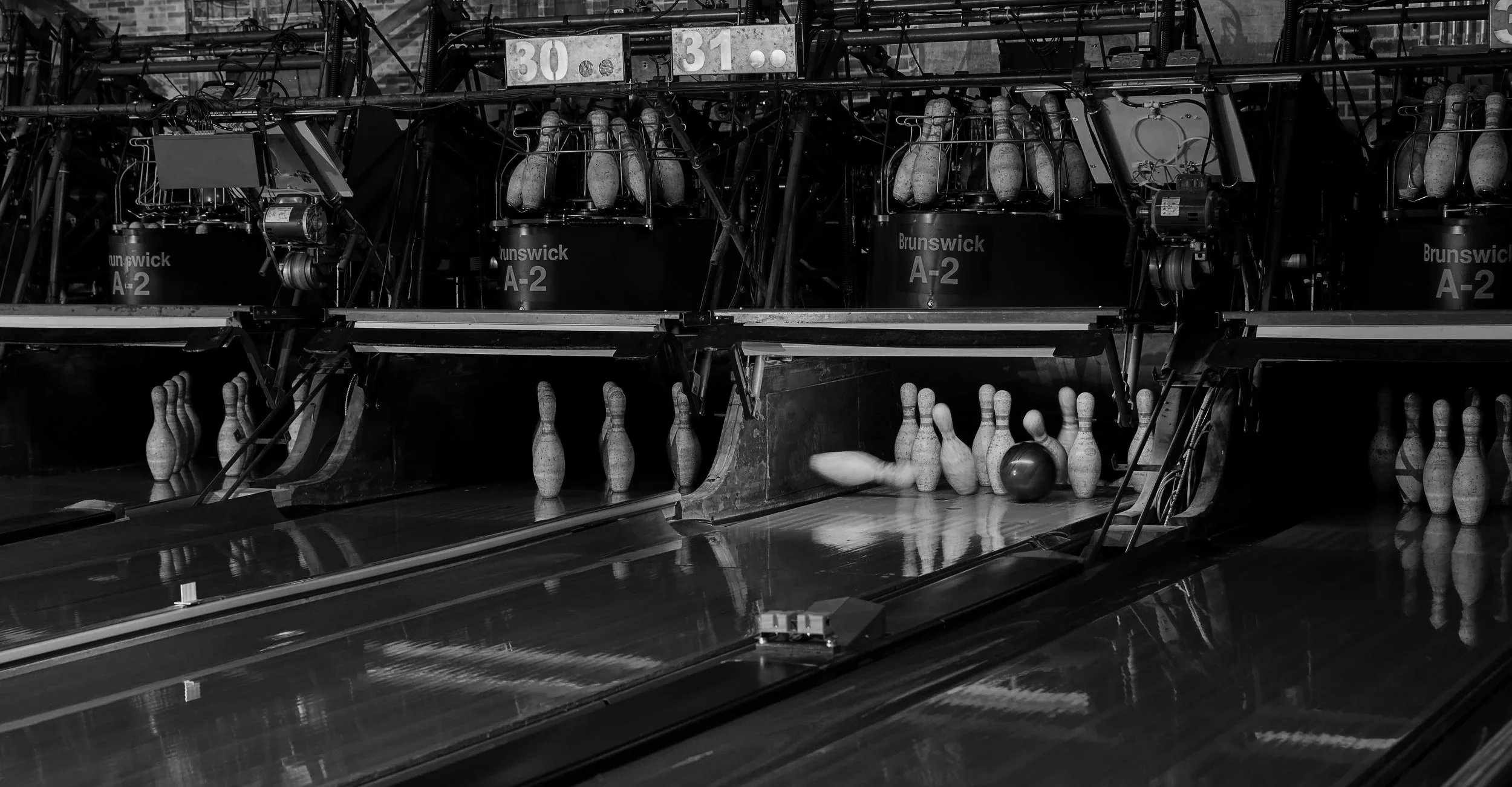 Vintage bowling pins and wood bowling lanes at Primrose Lanes