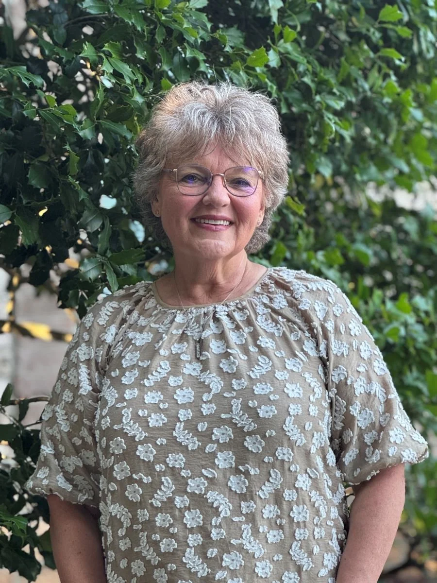 Pat Lawson smiling outside the Cary office.