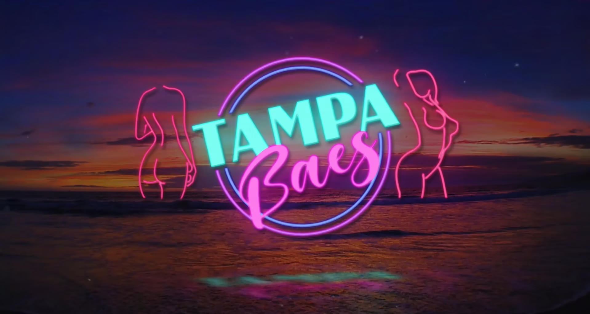 Neon sign reading 'Tampa Bare' with outline silhouettes of women on a sunset beach background.