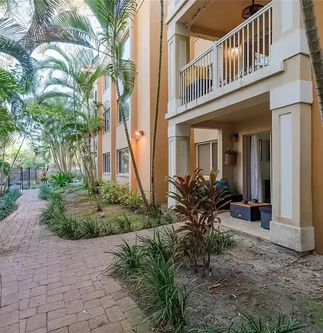 COURTYARD DUNEDIN Beautiful tropical courtyard exterior at Courtyard Dunedin vacation rentals in Dunedin, FL — offering stylish, sunlit accommodations near Pinellas Trail and Honeymoon Island, ideal for relaxing after a scenic excursion with Paradise
